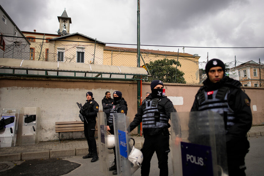 Turkish police officers stand guard in a cordoned-off area outside the Santa Maria church, in Istanbul, Turkey, Sunday, Jan. 28, 2024. (AP Photo/Emrah Gurel)